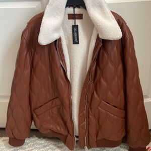 BlankNyc XL Sherpa lined polyester jacket in a rust color.